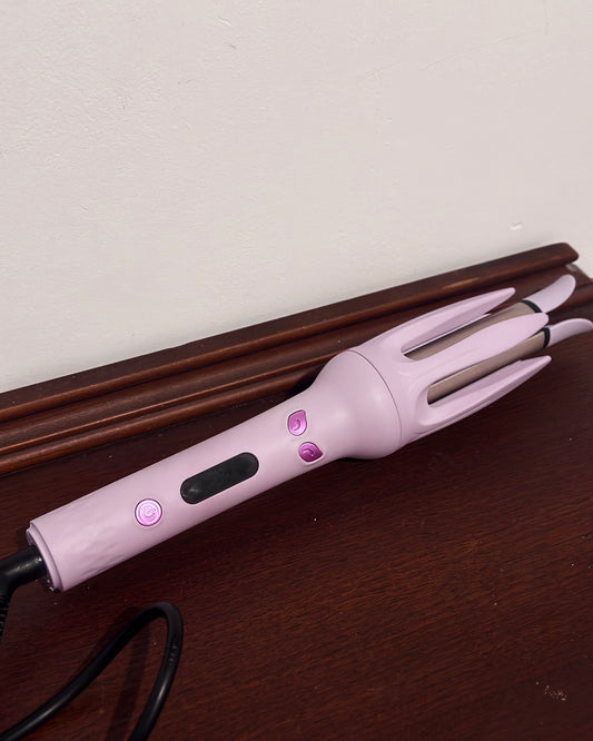 Auto rotating curling iron in mauve purple